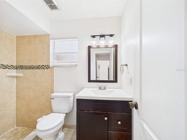 2434 Mill Run Blvd, Kissimmee, FL 34744 - full bathroom featuring toilet, tiled shower, vanity, and visible vents