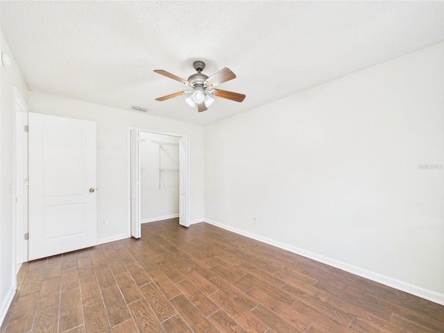 2434 Mill Run Blvd, Kissimmee, FL 34744 - unfurnished bedroom featuring baseboards, a closet, visible vents, and dark wood-type flooring
