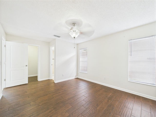 2434 Mill Run Blvd, Kissimmee, FL 34744 - unfurnished room featuring a textured ceiling, visible vents, dark wood-style flooring, a ceiling fan, and baseboards