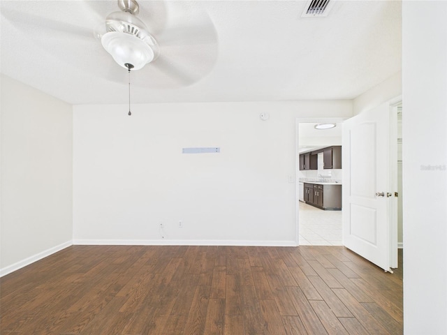 2434 Mill Run Blvd, Kissimmee, FL 34744 - empty room featuring visible vents, wood finished floors, baseboards, and ceiling fan