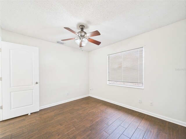 2434 Mill Run Blvd, Kissimmee, FL 34744 - unfurnished room with a ceiling fan, a textured ceiling, baseboards, dark wood finished floors, and visible vents