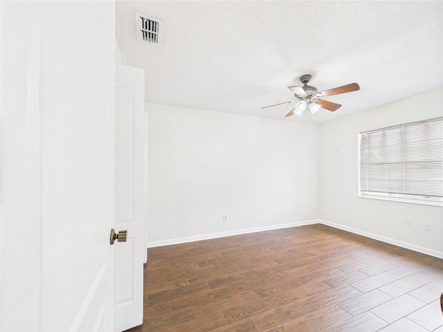2434 Mill Run Blvd, Kissimmee, FL 34744 - spare room with wood finished floors, a ceiling fan, a textured ceiling, visible vents, and baseboards
