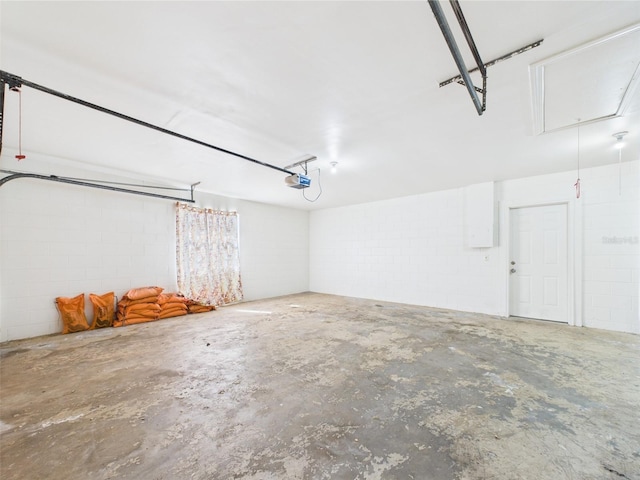 2434 Mill Run Blvd, Kissimmee, FL 34744 - garage with concrete block wall and a garage door opener