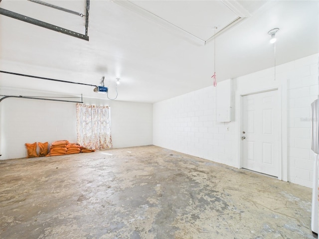 2434 Mill Run Blvd, Kissimmee, FL 34744 - garage with concrete block wall and a garage door opener
