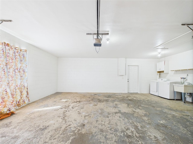 2434 Mill Run Blvd, Kissimmee, FL 34744 - garage featuring washing machine and dryer, a garage door opener, and concrete block wall