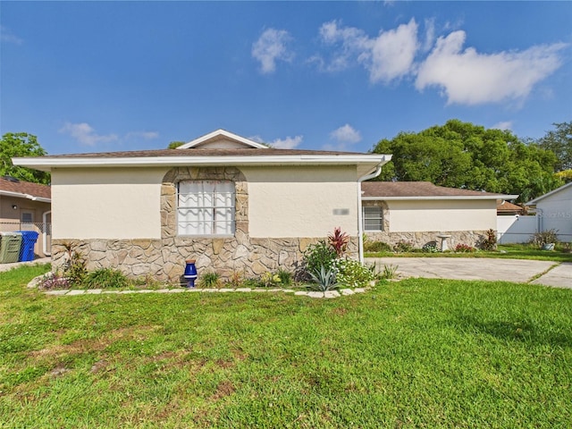 2434 Mill Run Blvd, Kissimmee, FL 34744 - view of side of home with a lawn, stone siding, and stucco siding