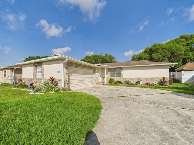 2434 Mill Run Blvd, Kissimmee, FL 34744 - single story home featuring stone siding, stucco siding, fence, a front yard, and driveway