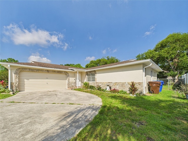 2434 Mill Run Blvd, Kissimmee, FL 34744 - ranch-style home featuring stone siding, a garage, fence, concrete driveway, and a front lawn