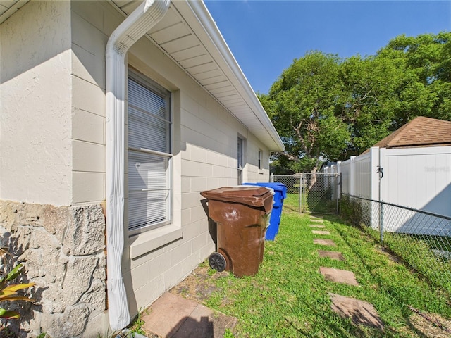 2434 Mill Run Blvd, Kissimmee, FL 34744 - view of property exterior featuring a gate, fence, and a lawn