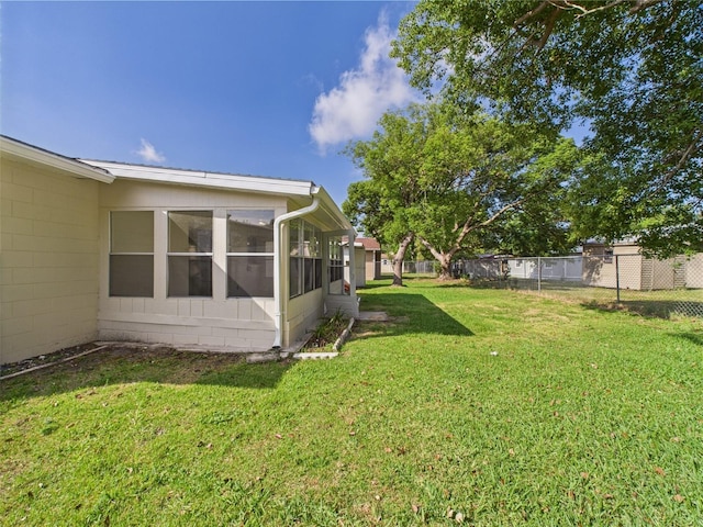 2434 Mill Run Blvd, Kissimmee, FL 34744 - view of yard featuring a sunroom and fence