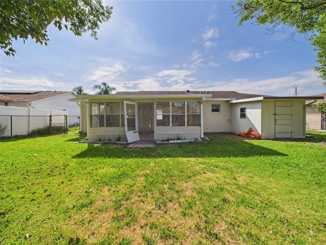2434 Mill Run Blvd, Kissimmee, FL 34744 - rear view of property with a yard, a sunroom, and fence