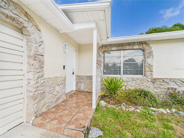 2434 Mill Run Blvd, Kissimmee, FL 34744 - doorway to property featuring stone siding and stucco siding