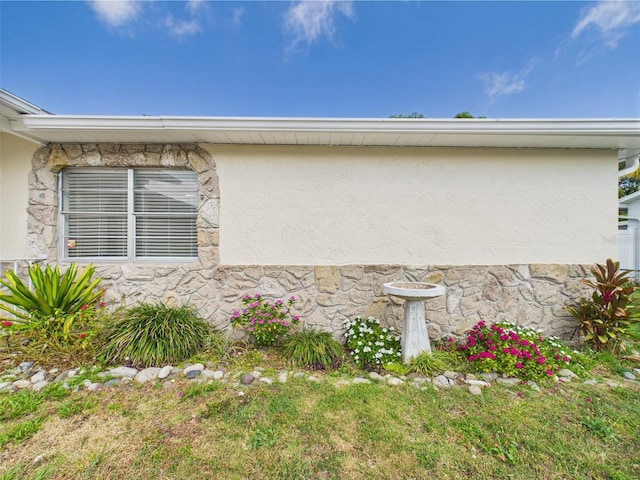 2434 Mill Run Blvd, Kissimmee, FL 34744 - view of property exterior featuring stone siding and stucco siding