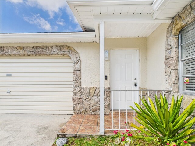 2434 Mill Run Blvd, Kissimmee, FL 34744 - doorway to property with stone siding and stucco siding