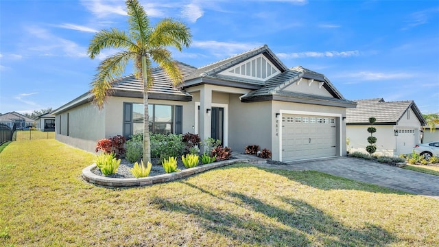 ranch-style home featuring decorative driveway, stucco siding, a front yard, a garage, and a tiled roof