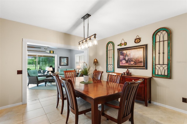 dining space with baseboards and light tile patterned floors