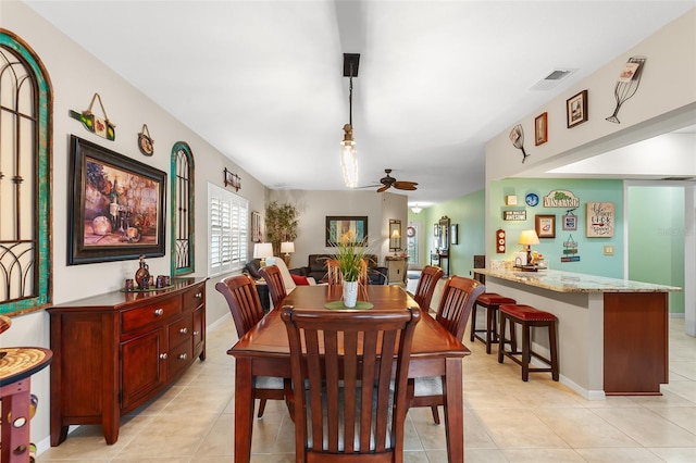 dining room featuring baseboards, light tile patterned flooring, visible vents, and a ceiling fan