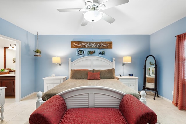 bedroom with ensuite bathroom, ceiling fan, light tile patterned flooring, and baseboards