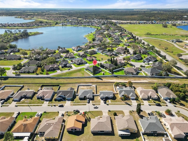 birds eye view of property featuring a water view and a residential view