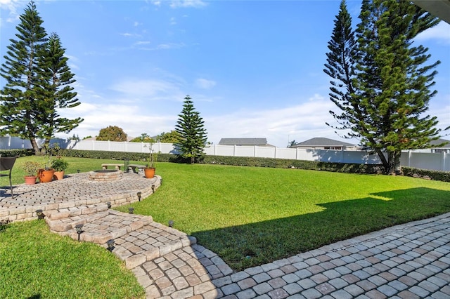 view of yard with a fire pit and a fenced backyard