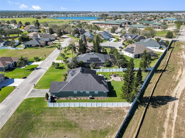 birds eye view of property featuring a water view and a residential view