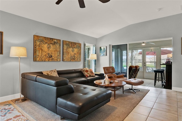 living room featuring light tile patterned floors, a ceiling fan, baseboards, vaulted ceiling, and french doors