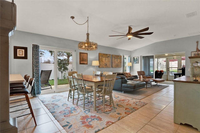 dining space featuring a healthy amount of sunlight, light tile patterned floors, visible vents, and vaulted ceiling