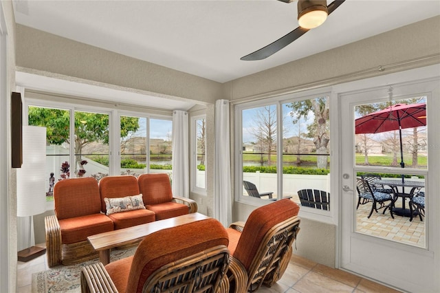 sunroom / solarium with a ceiling fan