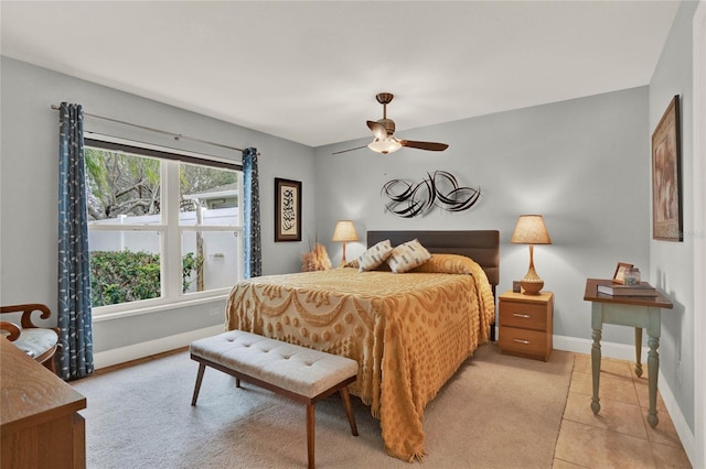 bedroom featuring light tile patterned flooring, ceiling fan, and baseboards