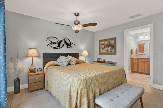 bedroom featuring light carpet, baseboards, visible vents, a ceiling fan, and connected bathroom