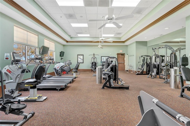 workout area with a drop ceiling, ceiling fan, and baseboards