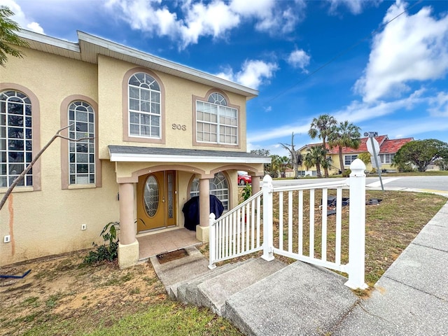 view of front facade featuring covered porch and stucco siding