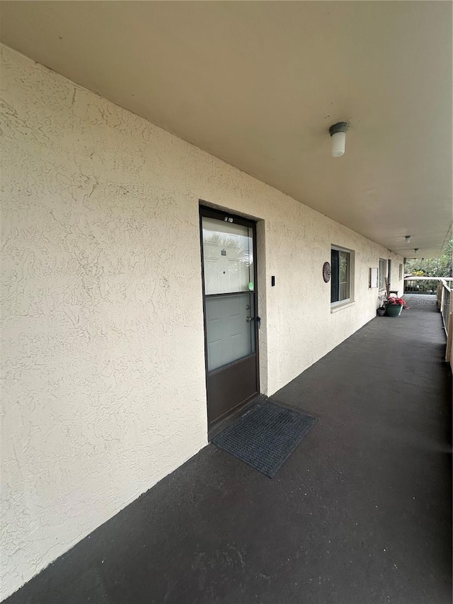 view of exterior entry featuring stucco siding