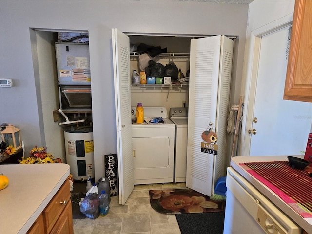 laundry area with laundry area, electric water heater, and independent washer and dryer