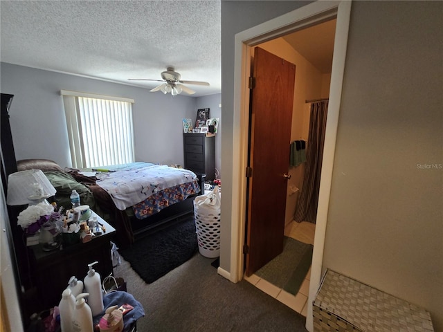 carpeted bedroom with ceiling fan and a textured ceiling