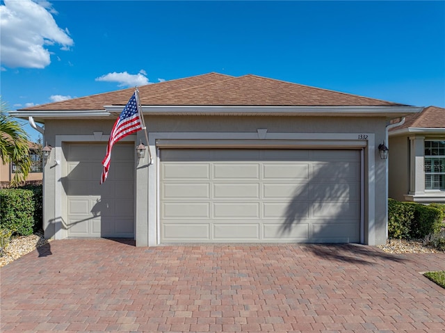 garage with decorative driveway