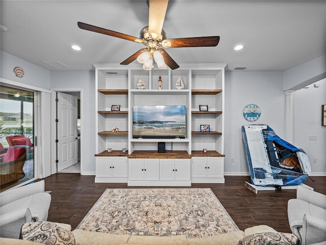 living area with decorative columns, baseboards, visible vents, dark wood-style flooring, and recessed lighting