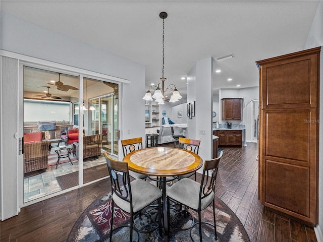 dining room featuring wood tiled floor, visible vents, ceiling fan with notable chandelier, and recessed lighting