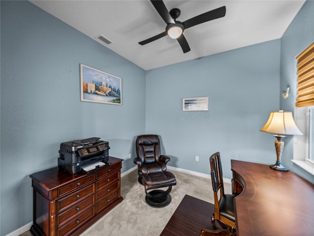 carpeted office featuring baseboards, visible vents, and a ceiling fan