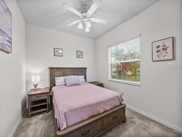 bedroom featuring baseboards, ceiling fan, and light colored carpet