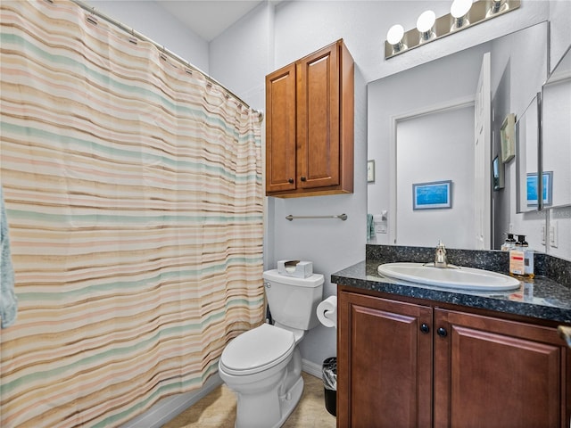 bathroom with toilet, vanity, and a shower with curtain