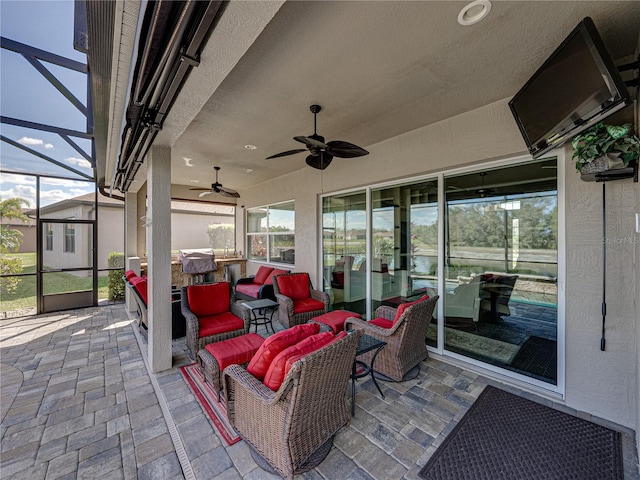 view of patio / terrace with a lanai, ceiling fan, and an outdoor living space