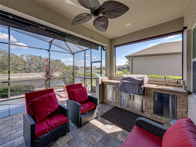 sunroom / solarium featuring a sink and a ceiling fan