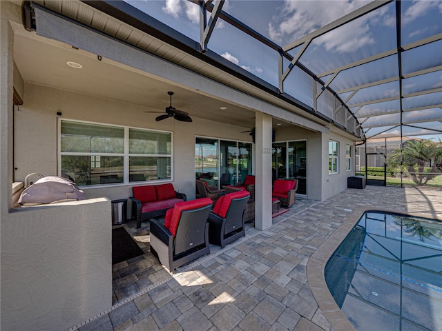 view of patio featuring a lanai, ceiling fan, and outdoor lounge area