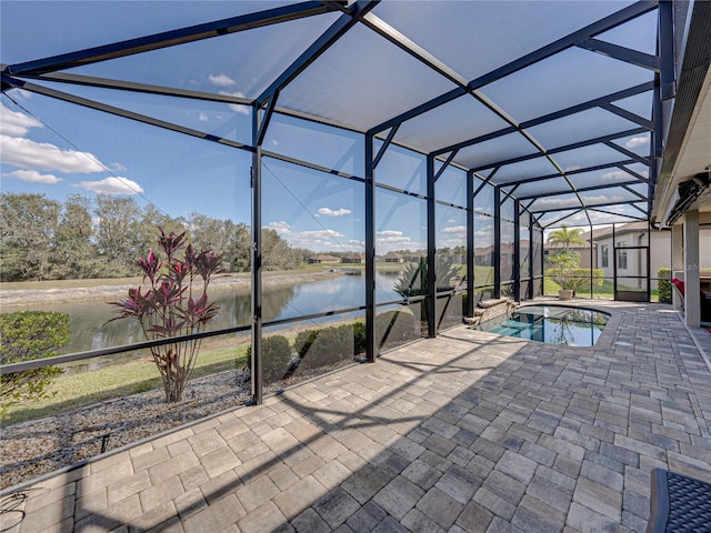 outdoor pool featuring a lanai, a water view, a hot tub, and a patio