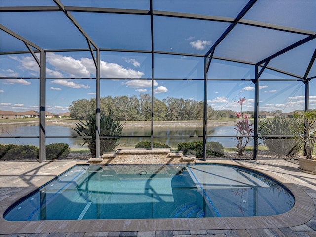 pool featuring a patio, a water view, and a lanai