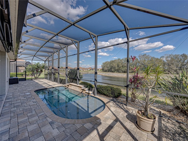 pool featuring a patio area, a lanai, and a water view