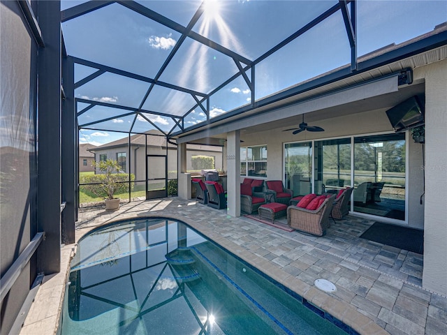 outdoor pool featuring glass enclosure, a patio area, ceiling fan, and outdoor lounge area