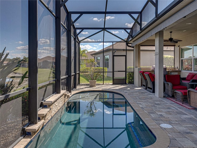 outdoor pool featuring ceiling fan, a patio, and a lanai