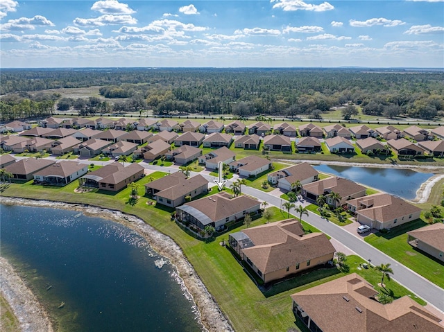 birds eye view of property featuring a water view and a residential view